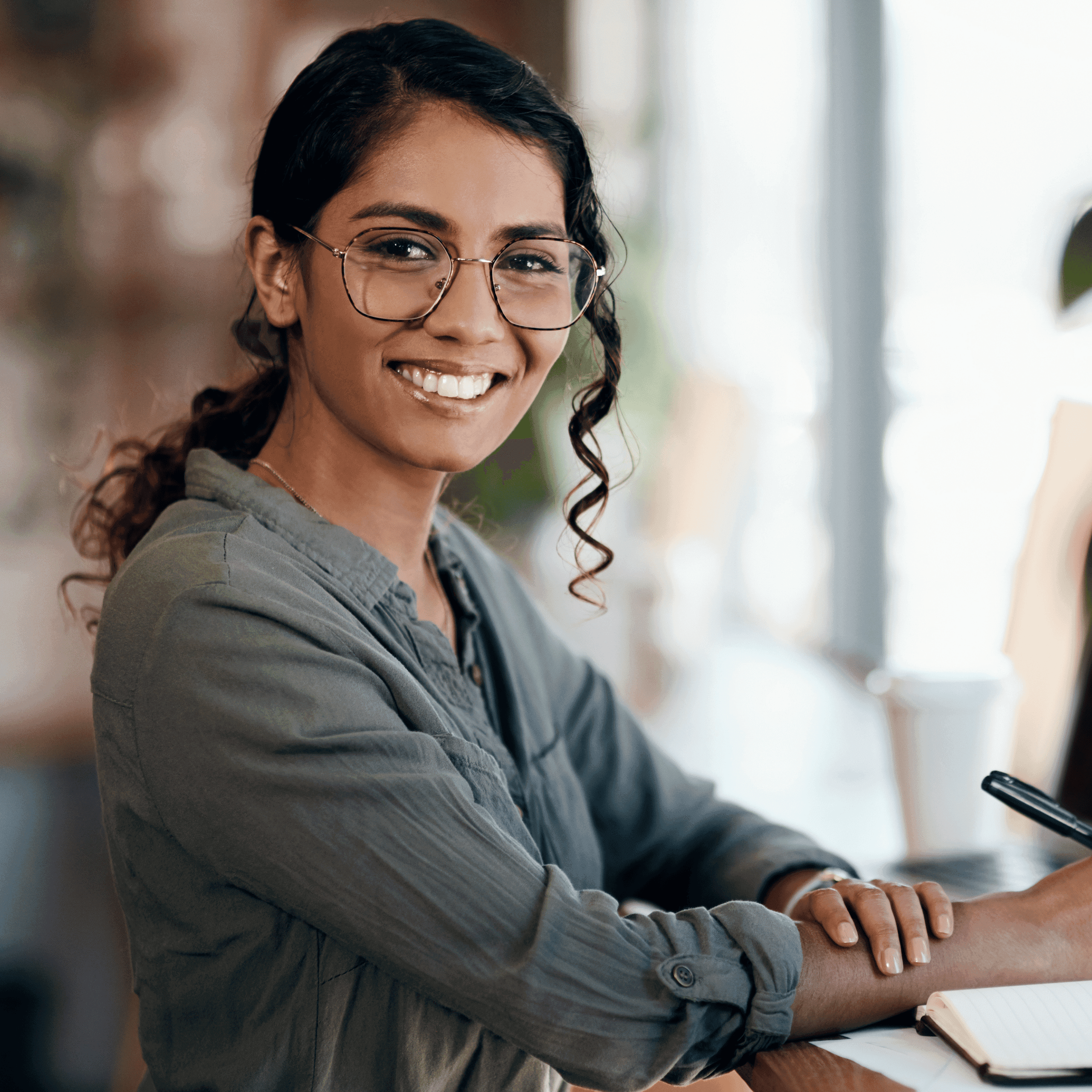 Woman wearing glasses and writing